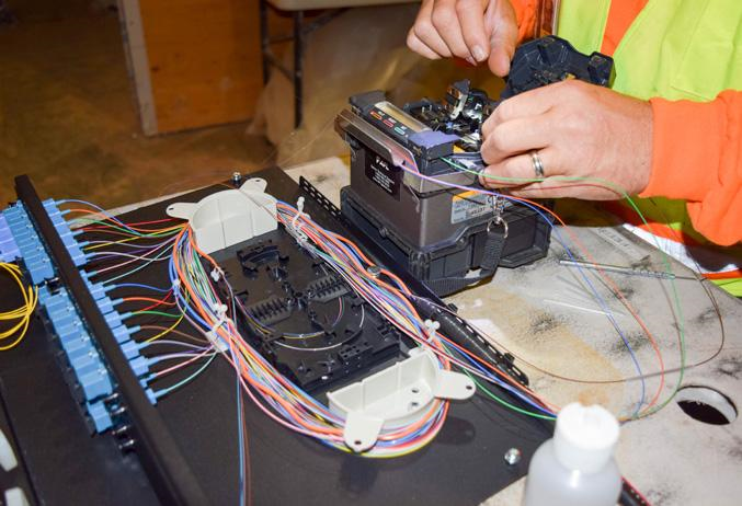 Engineer installing fibre optic telecommunications infrastructure